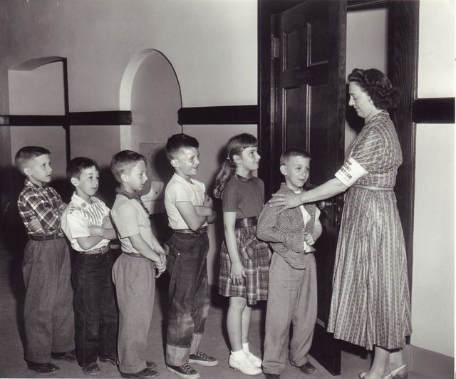 Kids line up to get their polio vaccines at the Woodbury Avenue School in Huntington, New York on April 27, 1954.